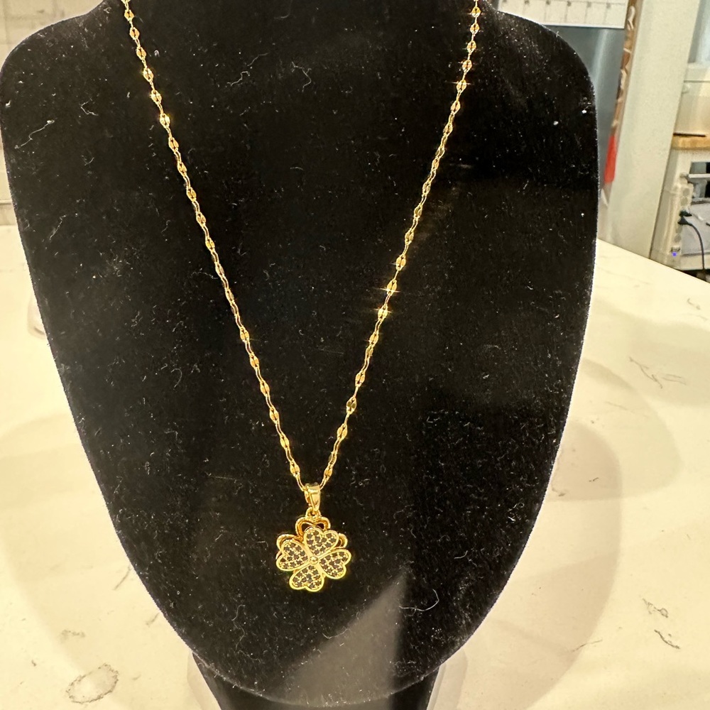 gold necklace with spinning pendent